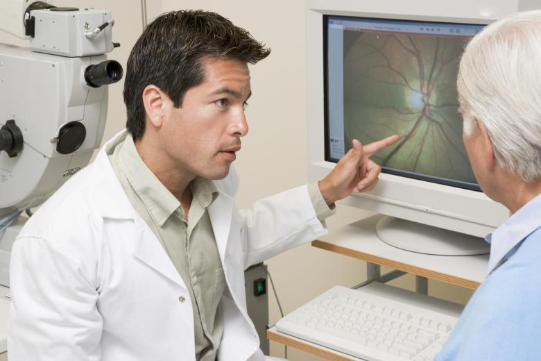 Man and his optometrist looking at the results of an eye exam.